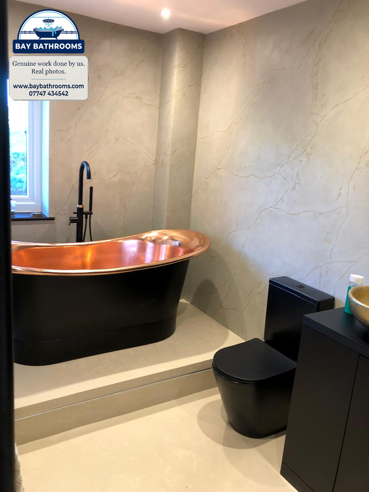 Copper roll-top bath on a microcement plinth